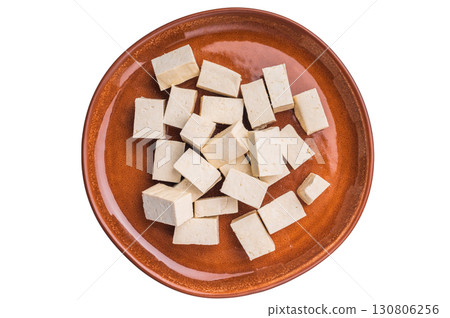 Uncooked Diced soybean tofu cheese on plate isolated on white background. top view 130806256
