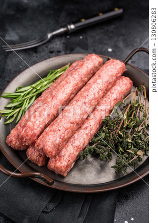 Fresh minced beef and lamb kebabs with fresh spices, arabic kofta kofte kebab. black background. top view 130806283