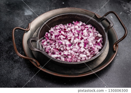 Chopped Red onion slices in steel tray. black background. top view 130806300