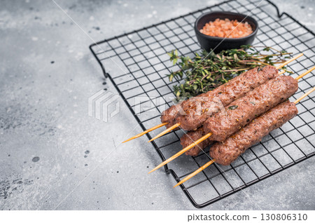 BBQ Roasted beef and lamb meat kebabs sausages, kofta kebab. grey background. top view BBQ Roasted beef and lamb meat kebabs sausages, kofta kebab. grey background. top view 130806310