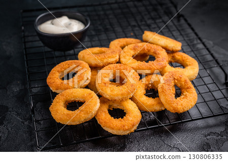 Ready or eat Deep Fried crunchy onion rings, delicious snack. black background. top view 130806335