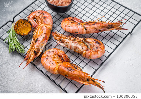Seafood BBQ with Grilled red Argentine shrimps, Prawns Langostino Austral on a rack with herbs. grey background. top view Seafood BBQ with Grilled red Argentine shrimps, Prawns Langostino Austral on a rack with herbs. grey background. top view 130806355