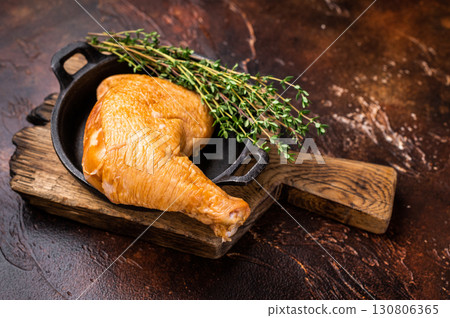 BBQ Smoked chicken leg, poultry meat in skillet. brown background. top view BBQ Smoked chicken leg, poultry meat in skillet. brown background. top view 130806365