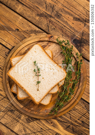 Ready for toasts Slices of wheat bread. wooden background. top view 130806382