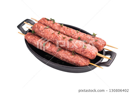 Raw shish kebab, arabic kofta kofte kebab from mince lamb and beef meat on Skewer isolated on white background. top view Raw shish kebab, arabic kofta kofte kebab from mince lamb and beef meat on Skewer isolated on white background. top view 130806402