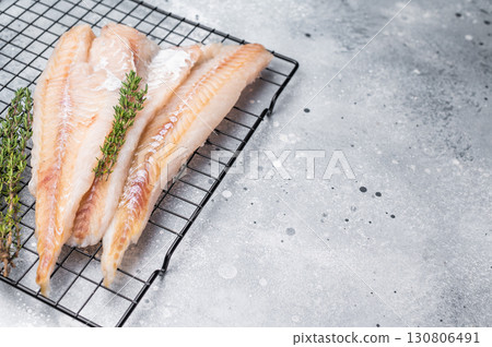 Raw pollock white fish fillet with thyme. grey background. top view 130806491