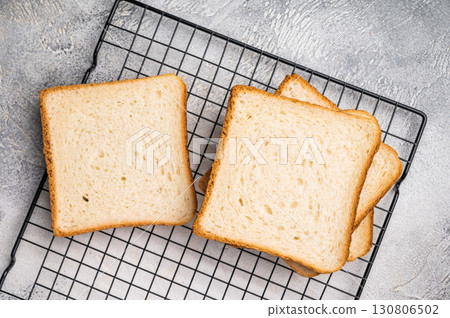 Square Slices of loaf wheat bread for toasts. white background. top view Square Slices of loaf wheat bread for toasts. white background. top view 130806502