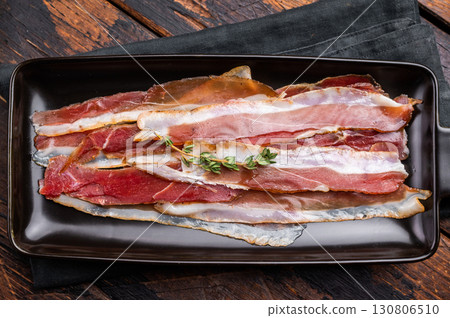 Smoked duck pastrami meat slices. wooden background. top view 130806510