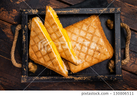 American hot Grilled cheese sandwich in wooden tray. wooden background. top view American hot Grilled cheese sandwich in wooden tray. wooden background. top view 130806511