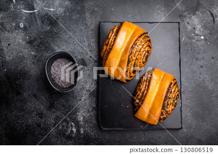 Sweet buns with poppy seed. black background. top view Sweet buns with poppy seed. black background. top view 130806519