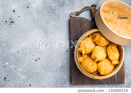 Japanese Taiyaki Fish Shaped Cake with Sweet Red Bean Paste. grey background. top view Japanese Taiyaki Fish Shaped Cake with Sweet Red Bean Paste. grey background. top view 130806534