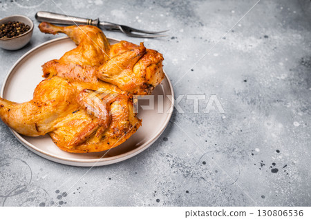 Roasted Spatchcock Chicken, poultry meat. grey background. top view Roasted Spatchcock Chicken, poultry meat. grey background. top view 130806536