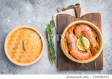 Steamed Red shrimps, Prawns in bamboo steamer. grey background. top view Steamed Red shrimps, Prawns in bamboo steamer. grey background. top view 130806542