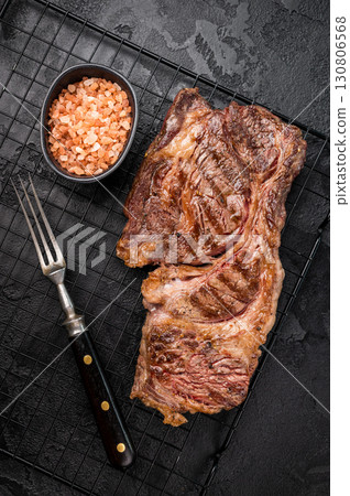 BBQ grilled Chuck eye roll steak, prime beef meat on a steel rack. black background. top view BBQ grilled Chuck eye roll steak, prime beef meat on a steel rack. black background. top view 130806568