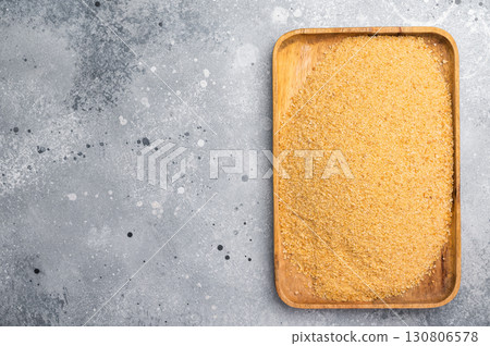 Homemade organic bread crumbs in a wooden tray. gray background. top view Homemade organic bread crumbs in a wooden tray. gray background. top view 130806578