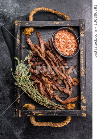 Beef fritter, Deep fried beef tender strips, sliced meat in a tray. black background. top view Beef fritter, Deep fried beef tender strips, sliced meat in a tray. black background. top view 130806593