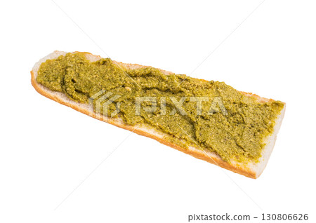 Delicious green pesto spread on toasted bread, garnished with herbs isolated on white background Delicious green pesto spread on toasted bread, garnished with herbs isolated on white background 130806626