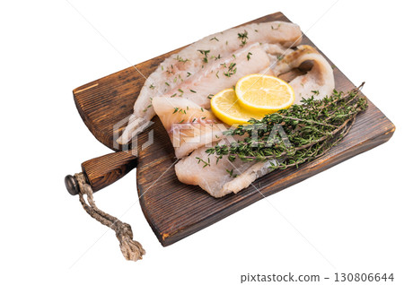 Haddock sea fish fillets, raw whitefish on a wooden board ready for cooking isolated on white background. top view 130806644