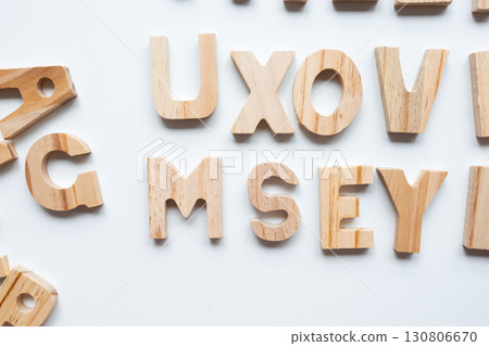 Wooden alphabet letters on white background in random arrangement 130806670