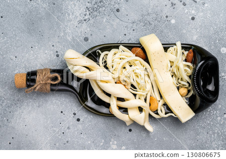 Cheese board with assortment of Chechil white cheese with nuts, gray background. 130806675