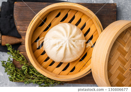 Chinese Bao or Baozi bun with meat in bamboo steamer. grey background. top view 130806677