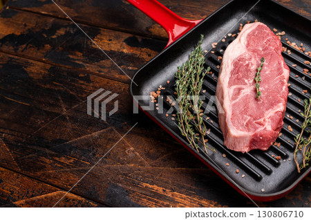 Fresh strip loin beef steak, striploin steak on a grill pan wooden background. top view 130806710