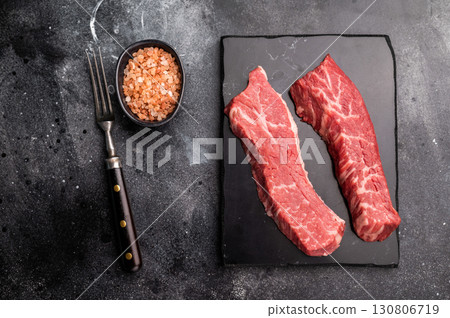 Raw Tri Tip Steak from Black Angus beef meat . black background. top view Raw Tri Tip Steak from Black Angus beef meat . black background. top view 130806719