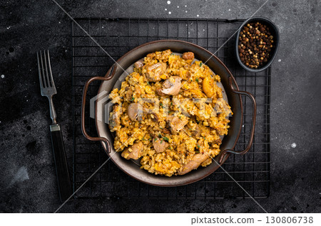 Arabic national rice food pilaf or plov, cooked with fried lamb and beef meat. black background. top view 130806738