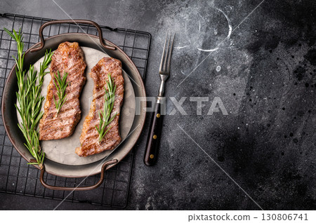 BBQ roast marbled beef Steak, beef meat on tray with herbs. black background. top view BBQ roast marbled beef Steak, beef meat on tray with herbs. black background. top view 130806741