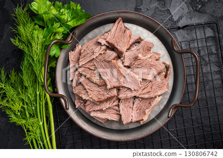 Boiled sliced beef meat in a steel tray. black background. top view Boiled sliced beef meat in a steel tray. black background. top view 130806742
