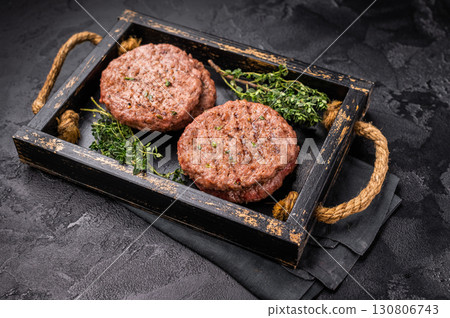 Grilled hamburger mince meat patties with herbs. black background. top view Grilled hamburger mince meat patties with herbs. black background. top view 130806743