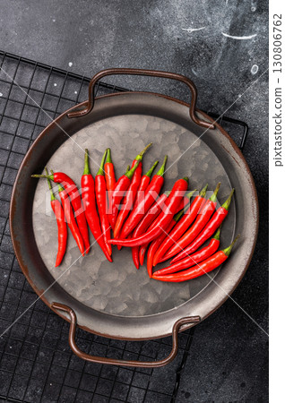 Hot Red chili peppers in a steel tray isolated on white background. top view Hot Red chili peppers in a steel tray isolated on white background. top view 130806762