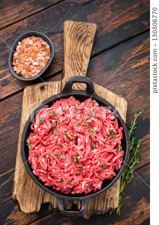 Veal beef raw mince meat, forcemeat in a skillet, on wooden background. 130806770