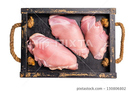Raw Chicken thighs fillets in a wooden tray isolated on white background Raw Chicken thighs fillets in a wooden tray isolated on white background 130806802