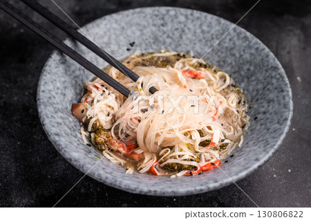 Asian glass noodles with crab meat and vegetables in a bowl. black background. top view 130806822