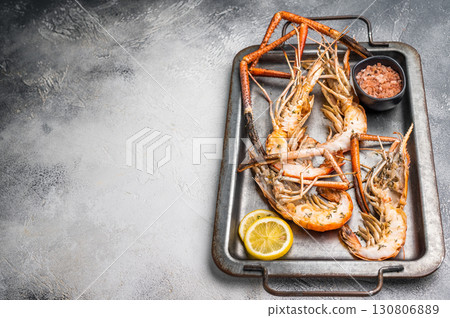 Deliciously grilled giant river prawns on steel tray, ideal for summer gatherings and outdoor feasts. white background. top view Deliciously grilled giant river prawns on steel tray, ideal for summer gatherings and outdoor feasts. white background. top view 130806889
