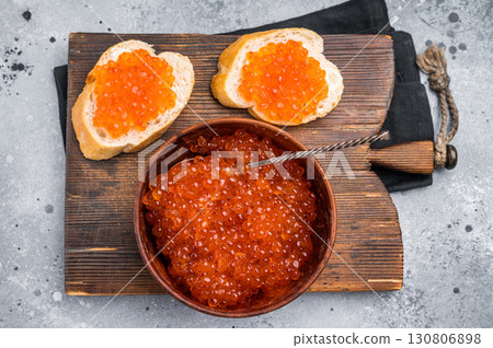 Salty salmon roe, red caviar, ideal for adding a touch of elegance to your culinary creations. grey ackground. top view Salty salmon roe, red caviar, ideal for adding a touch of elegance to your culinary creations. grey ackground. top view 130806898