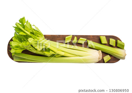 Raw uncooked celery sticks on wooden cutting board isolated on white background, top view Raw uncooked celery sticks on wooden cutting board isolated on white background, top view 130806950