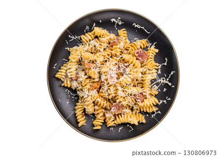 Fusilli carbonara pasta topped with crispy bacon bits and parmesan cheese in a plate isolated on white background 130806973