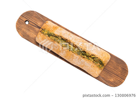 Garlic bread with herbs on wooden cutting board isolated on white background Garlic bread with herbs on wooden cutting board isolated on white background 130806976