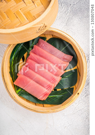 Artful presentation of fresh tuna sashimi, a deliciously healthy choice that delights the senses and pleases the palate. white background. top view 130807048