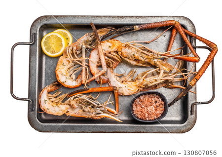 Deliciously grilled giant river prawns on steel tray, ideal for summer gatherings and outdoor feasts. isolated on white background. top view 130807056