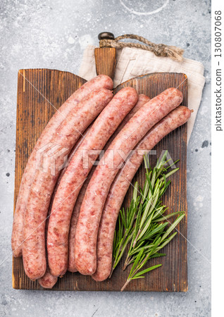 Freshly made raw sausage displayed elegantly, perfect for gourmet cooking or casual gatherings with friends. grey background. top view 130807068