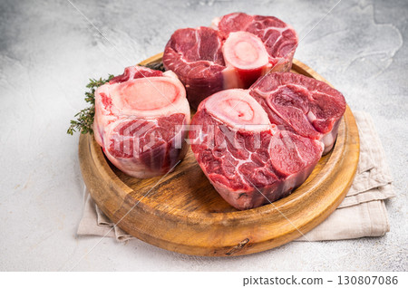 Beautifully marbled raw veal ossobuco, perfect cross cut shank meat for traditional Italian recipes and savory family dinners. white background. top view Beautifully marbled raw veal ossobuco, perfect cross cut shank meat for traditional Italian recipes and savory family dinners. white background. top view 130807086