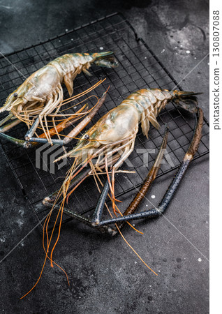 Fresh raw rosenbergii shrimp prawn, perfect for gourmet dishes and seafood lovers seeking premium quality.black background. top view 130807088