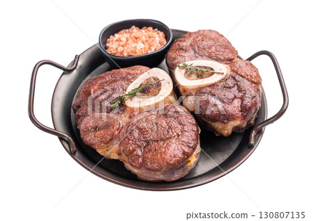 Deliciously braised ossobuco, featuring tender osso buco veal shank and rich marrow, perfect for a gourmet Italian feast. isolated on white background. top view Deliciously braised ossobuco, featuring tender osso buco veal shank and rich marrow, perfect for a gourmet Italian feast. isolated on white background. top view 130807135