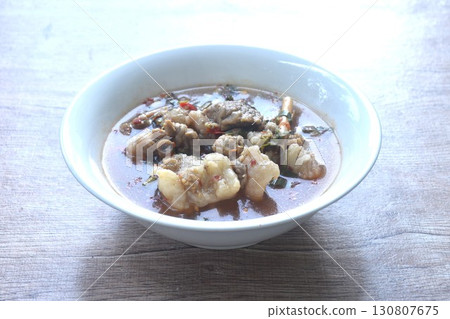 boiled slice braised beef meat with chili in clear tom yum soup on bowl  130807675