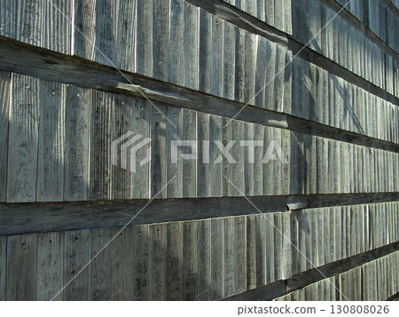 An old wooden fence illuminated by slanting sunlight in winter 130808026