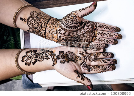 Picture of human hand being decorated with henna tattoo,Decorated Mehendi cone in Indian wedding ceremony Picture of human hand being decorated with henna tattoo,Decorated Mehendi cone in Indian wedding ceremony 130808993