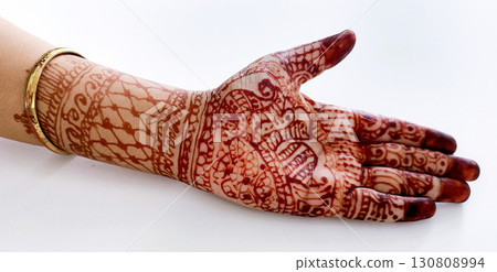 Beautiful Indian female hands with henna tattoo isolated on white Beautiful Indian female hands with henna tattoo isolated on white 130808994
